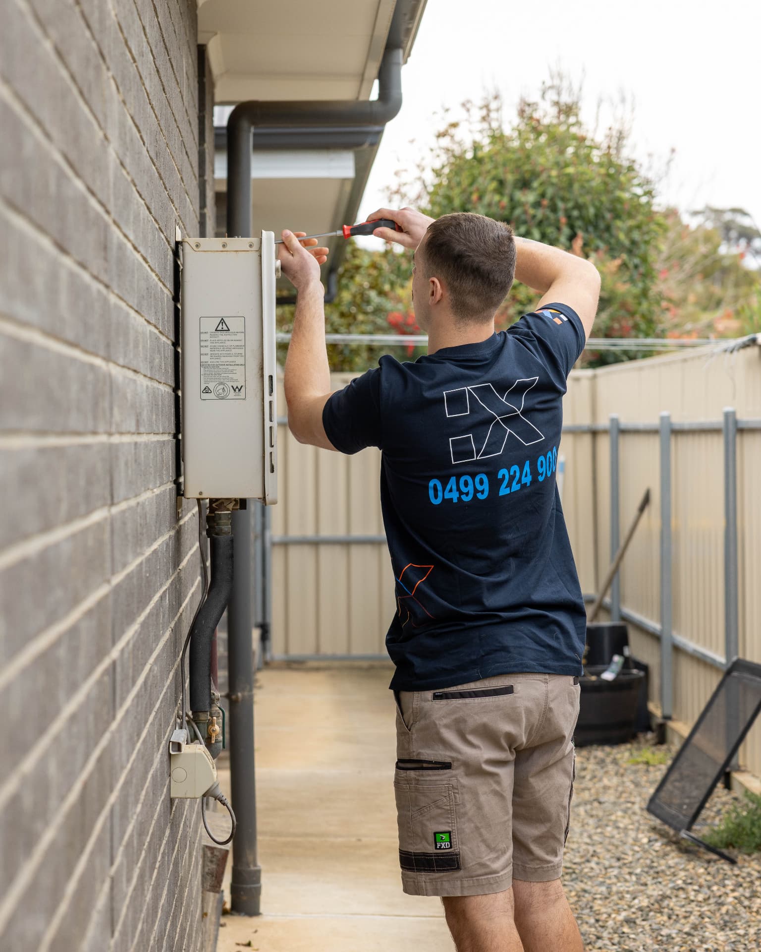 Fixara plumber servicing a gas hot water unit