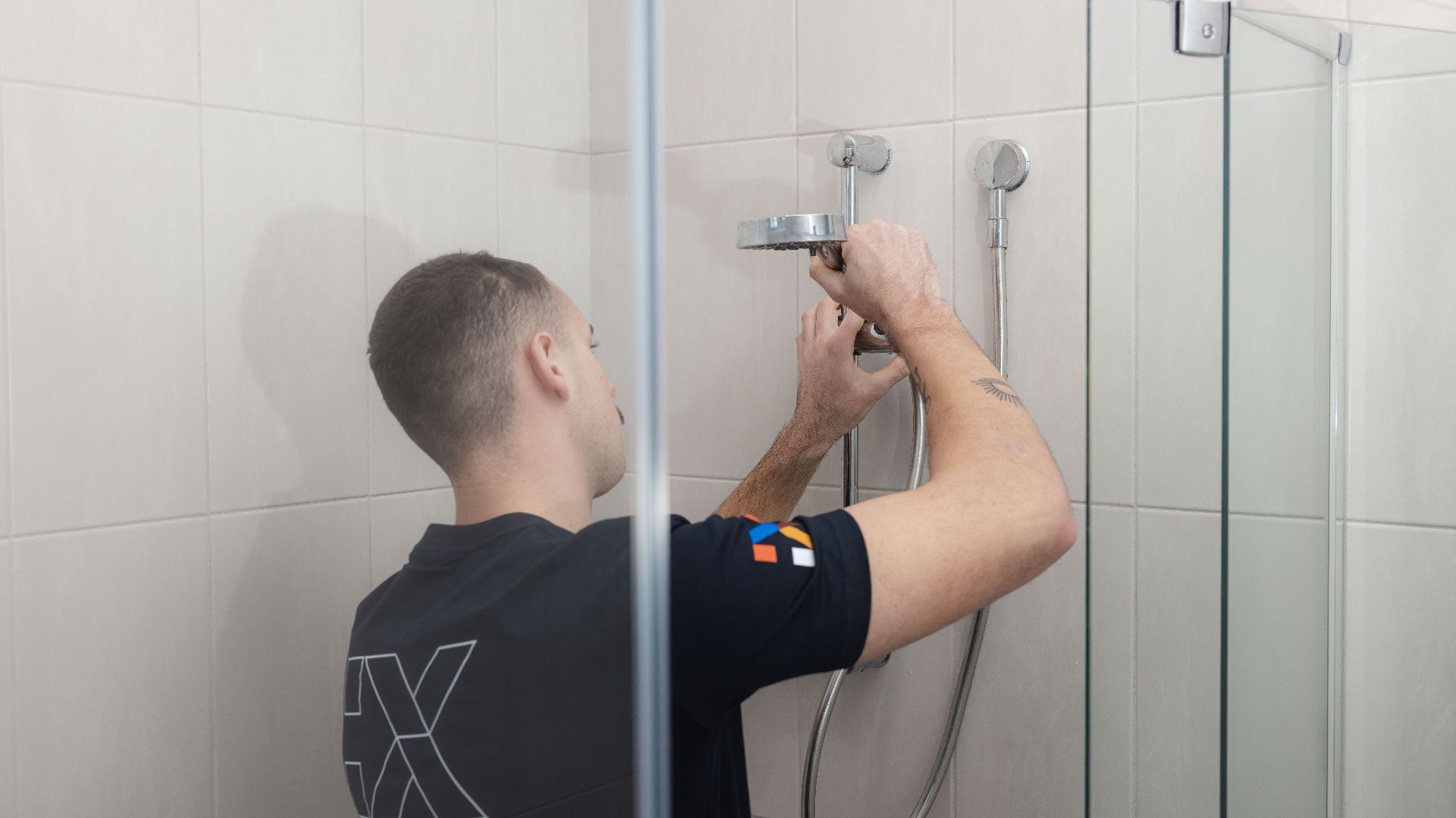 Fixara plumber installing a new shower head and rail